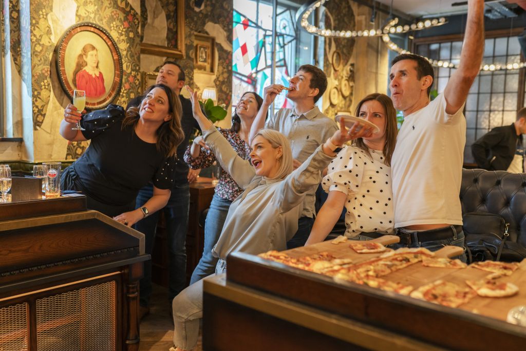 A group of people celebrating a game of social darts  