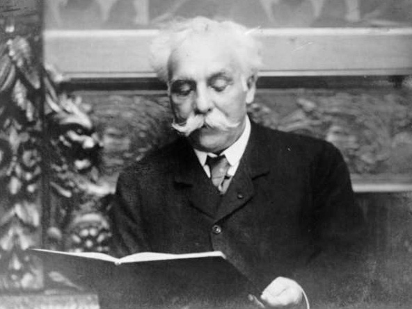 Gabriel Fauré pictured in 1907 reading a book