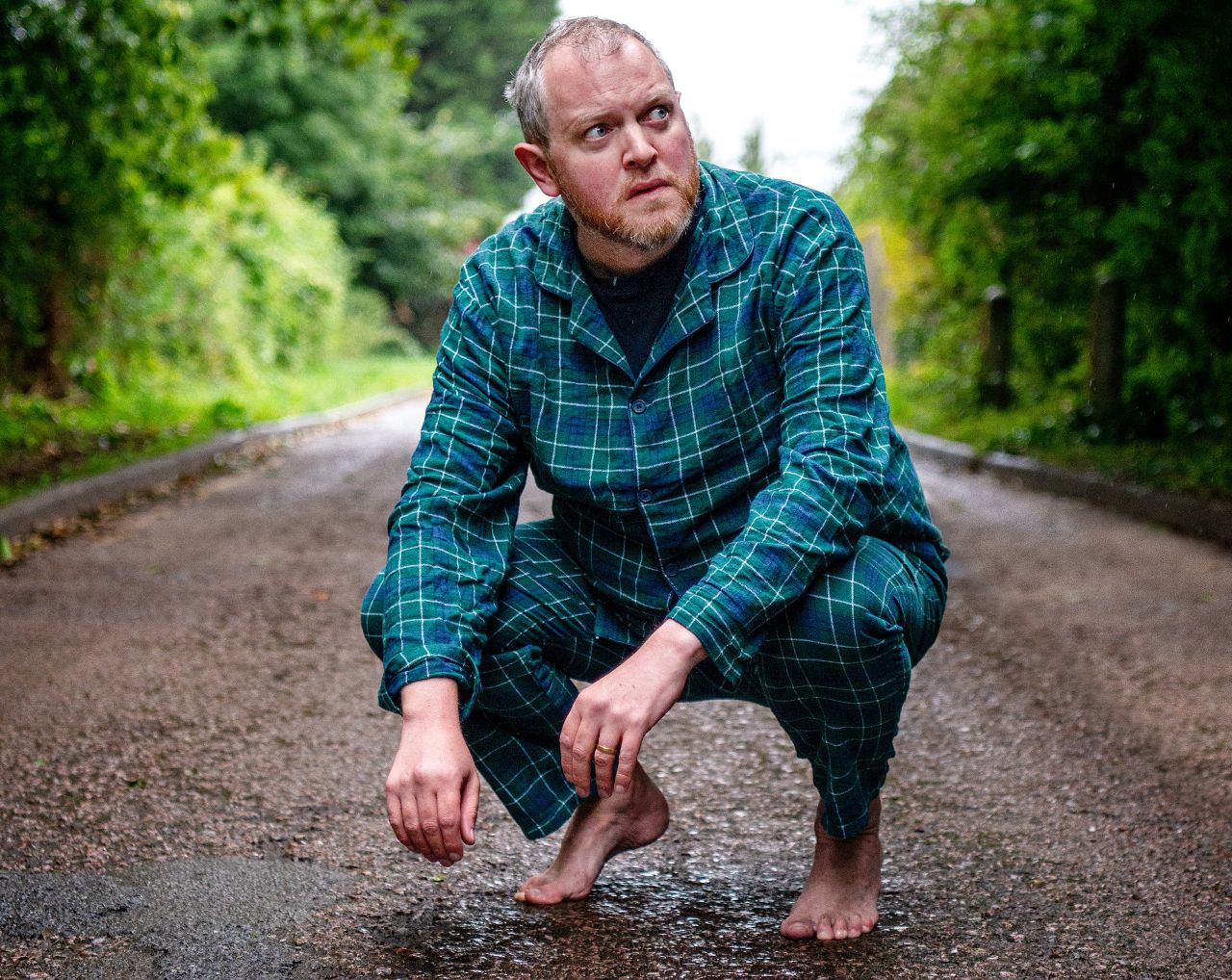 Miles Jupp in his jim jams, barefooted and in a street