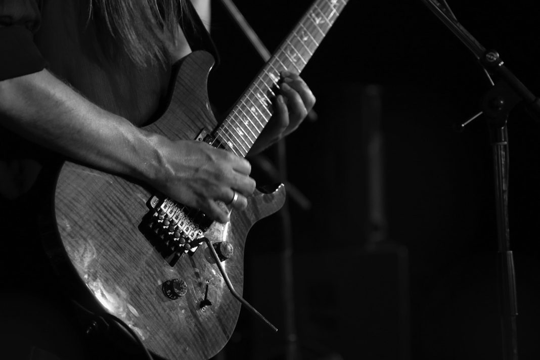 A guitarist playing in a gig