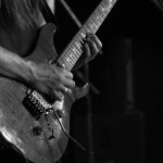 A guitarist playing in a gig