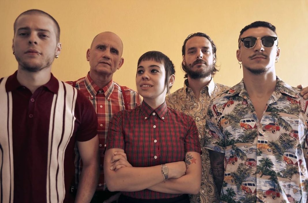 Los Fastidios band members standing in a row