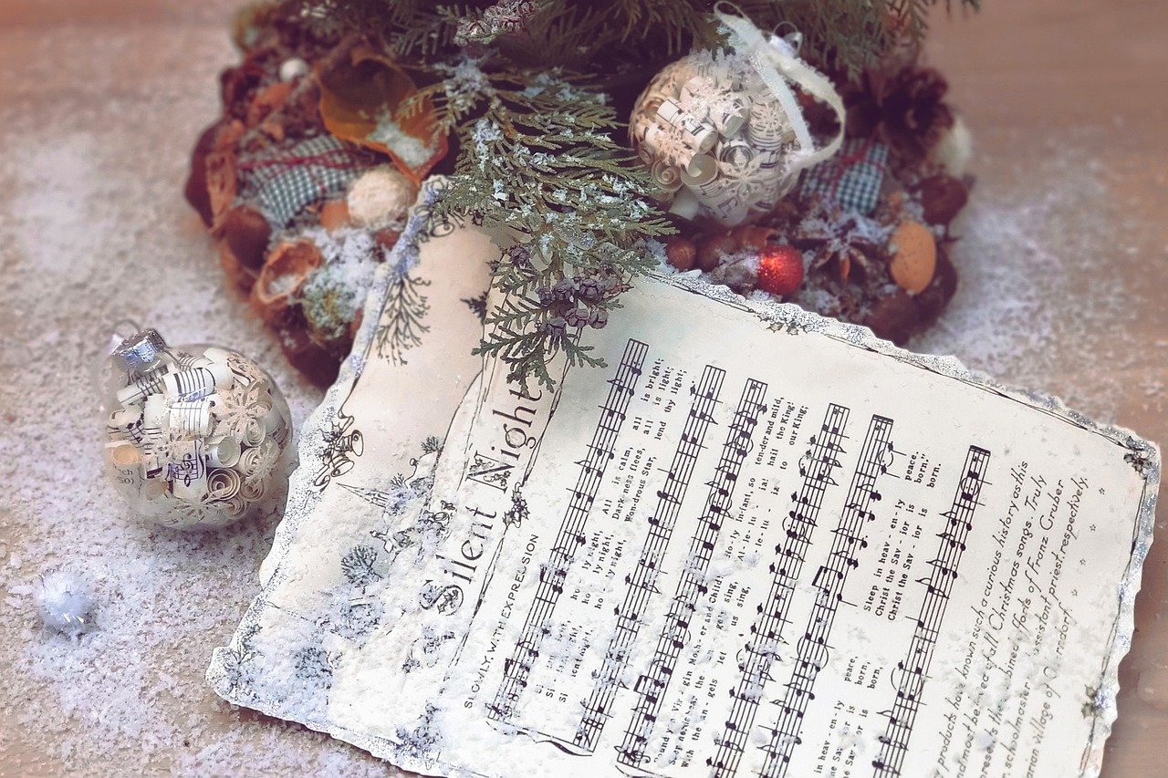 Sheet music for Silent Night next to Christmas decorations