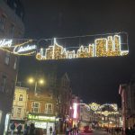 Reading's Christmas lights. This display shows an image of Reading's skyline, and in the background are shops and a lamppost. The image has been taken at night so the lights are on