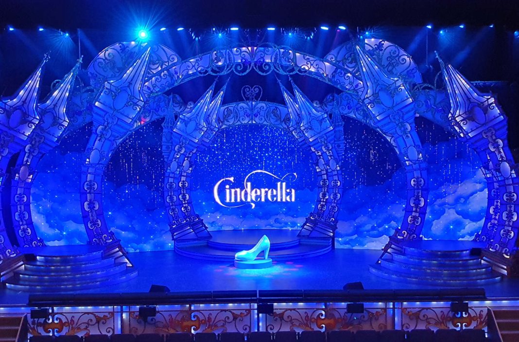 The digital set for Cinderella, coming to The Hexagon this Christmas. The image shows a giant shoe on the stage, with the word Cinderella visible on the screen