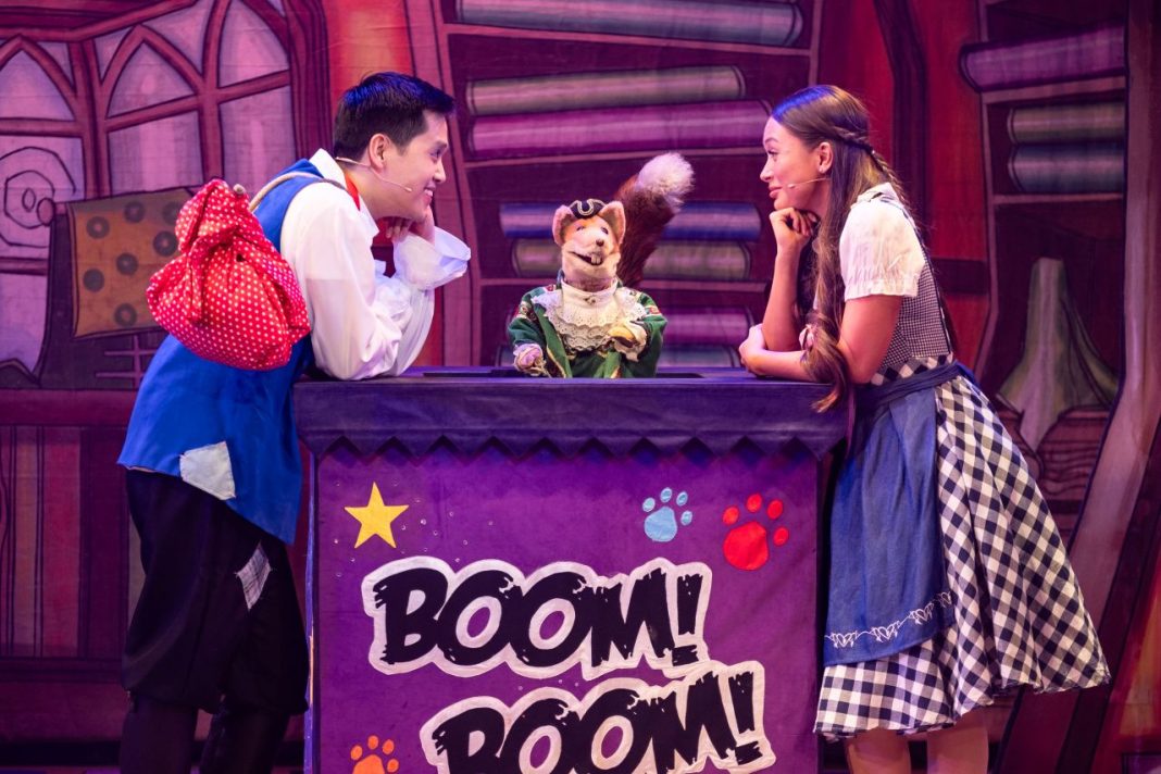 Basil Brush (centre) with Mikko Juan (left) and Mia Welsh (right). The two actors are leaning on their elbows looking in