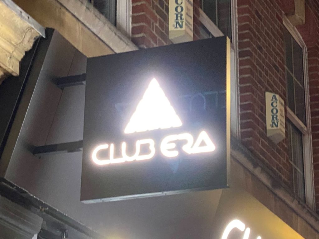 The sign for Club Era in Friar Street, lit up at night