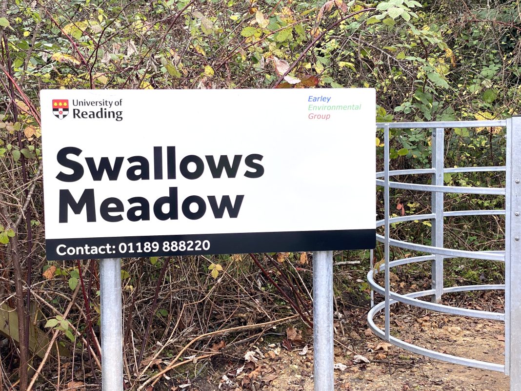 The sign at the entrance of Swallows Meadow and part of the kissing gate