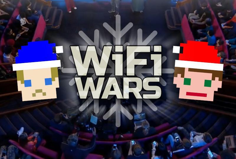 The logo for WiFi Wars featuring two faces made from pixels. They are wearing Santa hats - on the left a blue hat, on the right, a red hat. In the middle is a snowflake on top of which are the words WiFi Wars