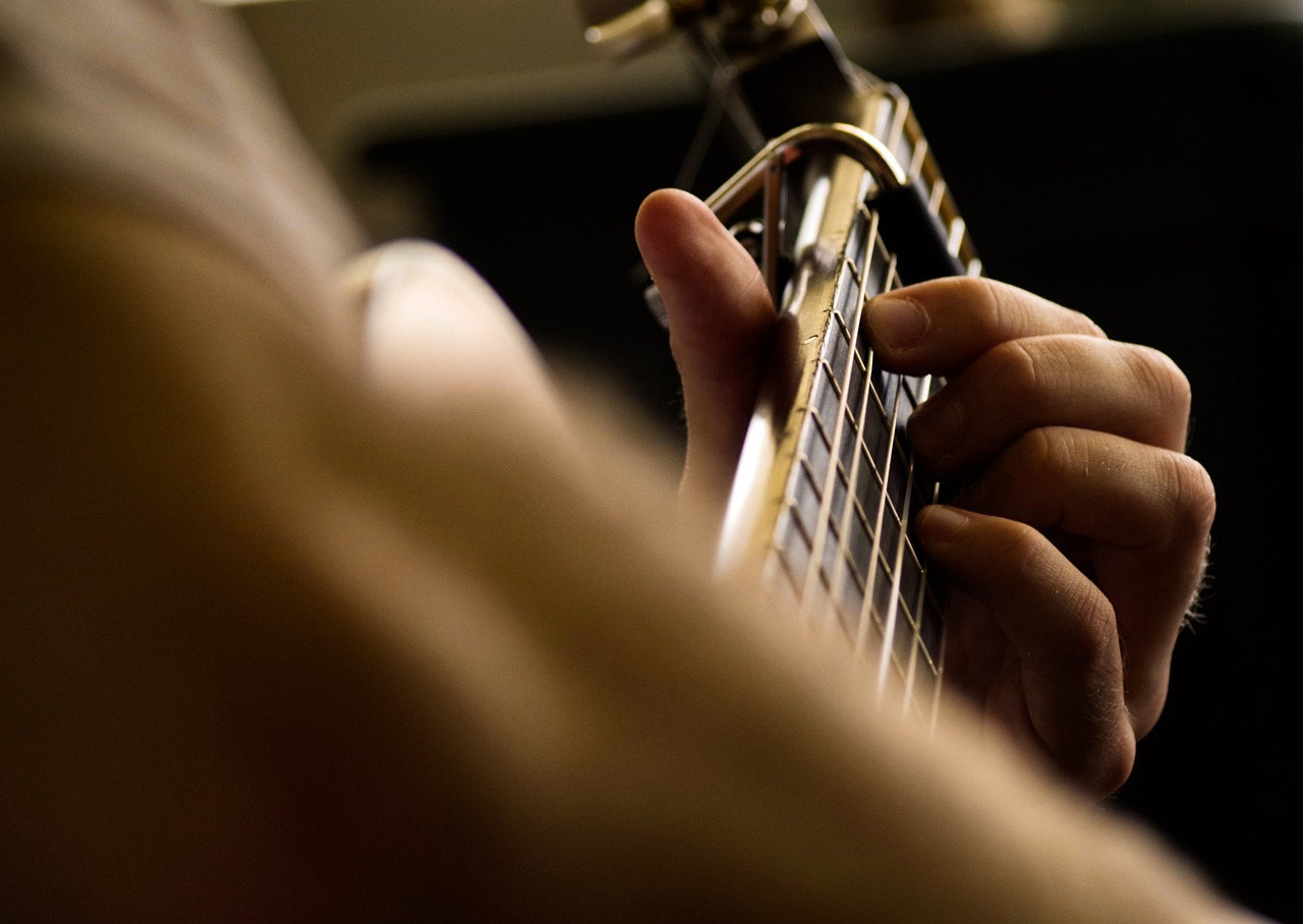 A close-up of a guitar being played by a musician