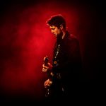 Aynsley Lister playing a guitar