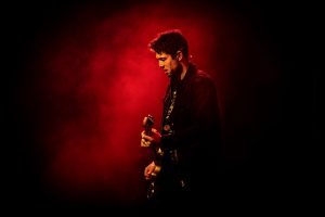 Aynsley Lister playing a guitar