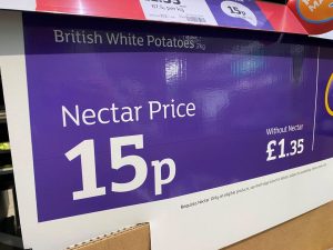 a purple box with white text and numbers on it showing the price of a 2kg bag of potatoes at Sainsbury's - for Christmas dinner