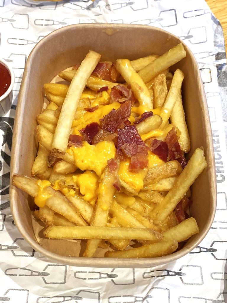 a container of french fries with bacon and cheese at Wendy's