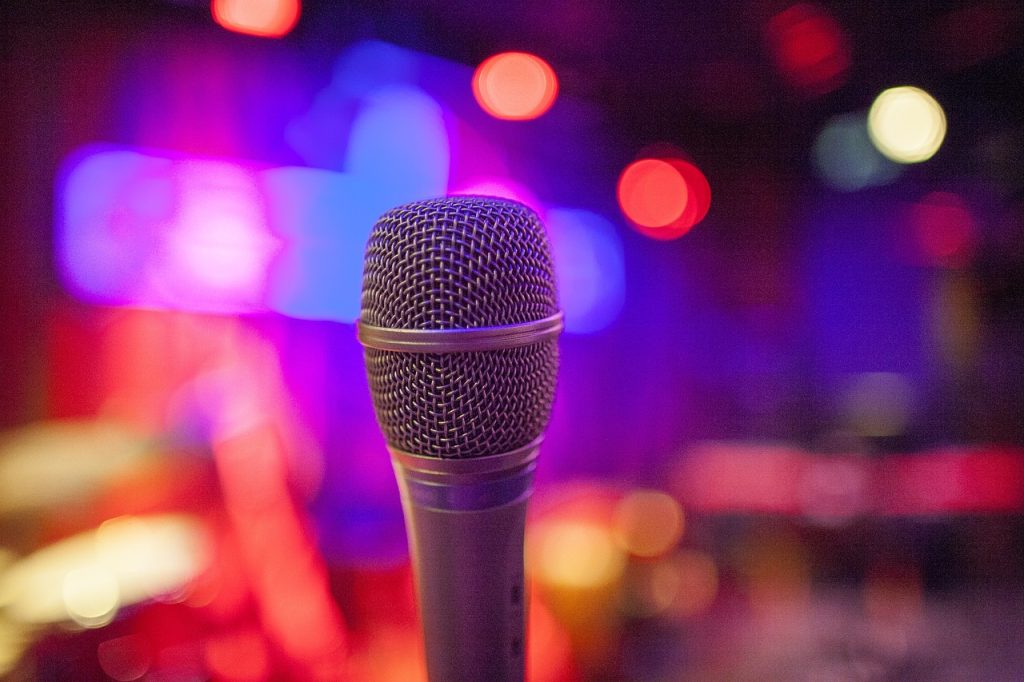 Poets Café returns with an opportunity for anyone to grab the microphone. Pictured is a microphone by itself with a blurred background - Nia Broomhall
