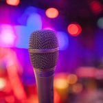 Poets Café returns with an opportunity for anyone to grab the microphone. Pictured is a microphone by itself with a blurred background - Nia Broomhall