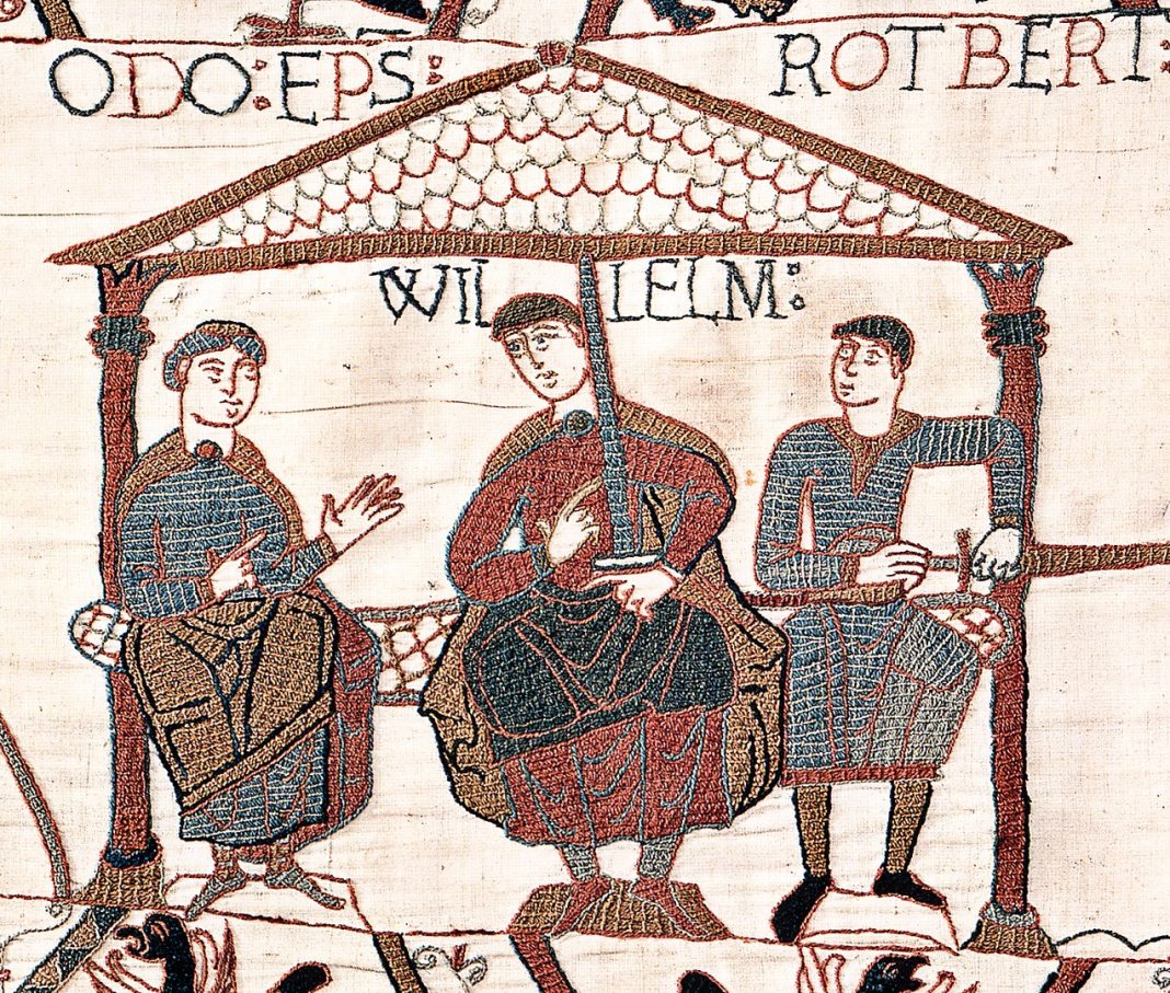 Image from the Bayeux Tapestry showing William The Conqueror with his half-brothers. William is in the centre, Odo is on the left with empty hands, and Robert is on the right with a sword in his hand