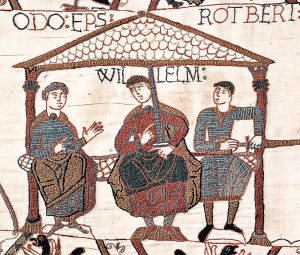 Image from the Bayeux Tapestry showing William The Conqueror with his half-brothers. William is in the centre, Odo is on the left with empty hands, and Robert is on the right with a sword in his hand