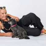 Barb Jungr lying on her side petting a dog