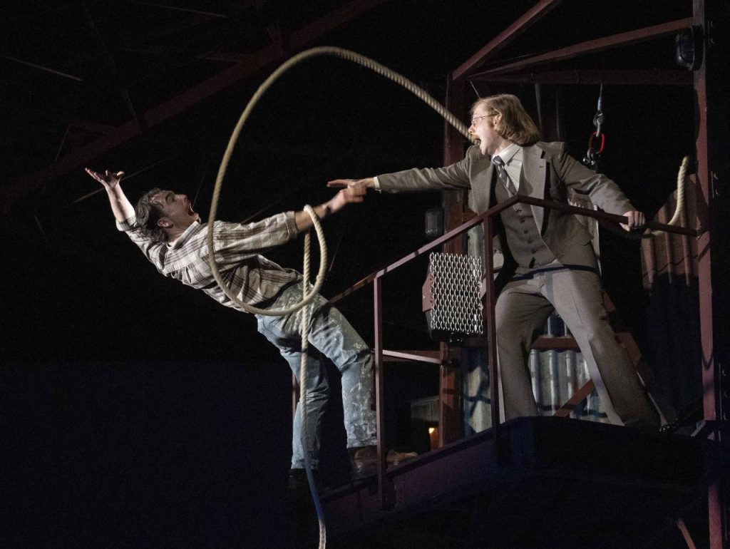 A man falling off a balcony in a scene from Boys From The Blackstuff