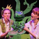 The Frog and the Princess is coming to Norden Farm - two actors, one poking their tongue out, hold a puppet frog