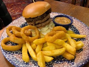 The Caledonian burger – two 3oz beef patties, with haggis and whisky sauce, served with chips and six beer-battered onion rings – on the menu at Wetherspoon for Burns Week 2025