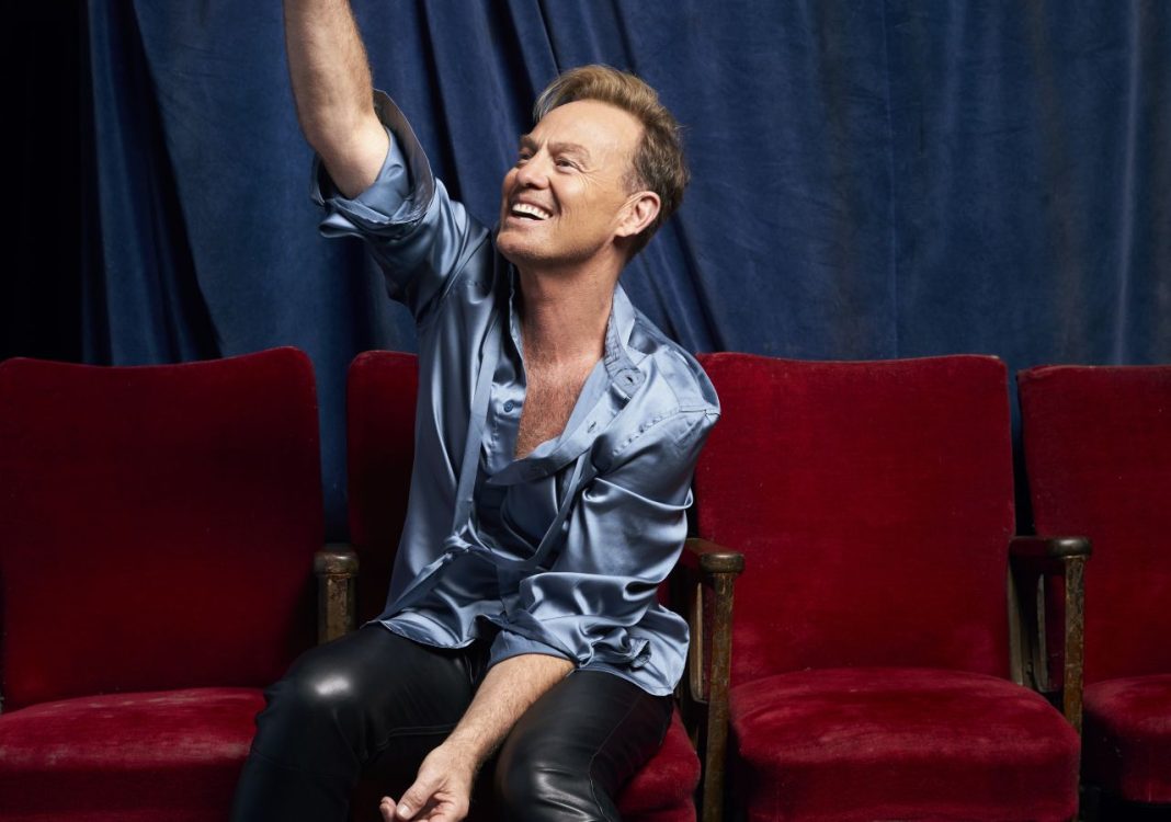 Jason Donovan pointing upwards