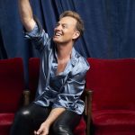 Jason Donovan pointing upwards