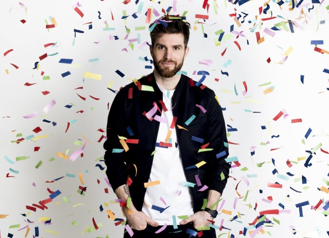 Joel Dommett with confetti coming down around him