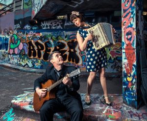 a man playing an instrument next to a woman to promote the Oh la la! Quintet