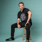 Russell Hicks sitting on a stool