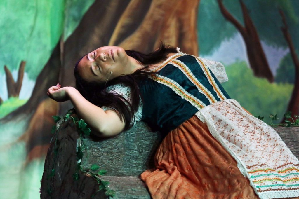 a woman lying on a rock in Sleeping Beauty at the Shinfield Players