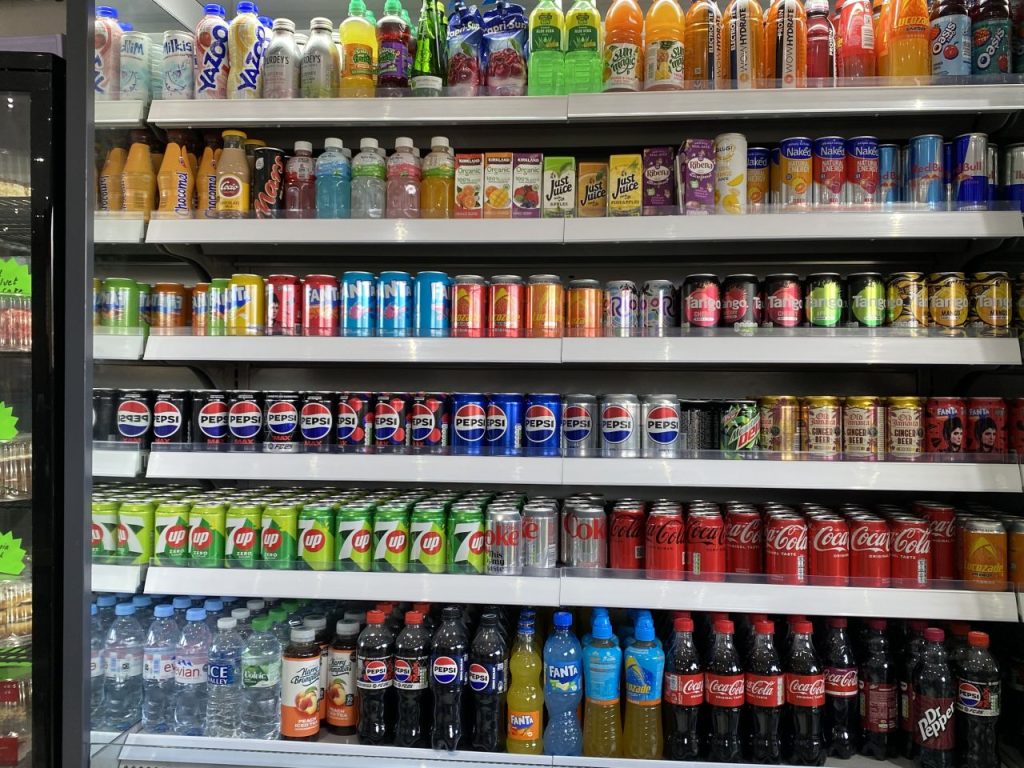 The chiller cabinet at Woodley Café features a range of cans