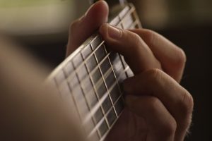 A person playing the guitar. Sunday concerts