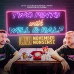 Ralf Little and Will Mellor sitting either side of a desk with a sign behind them that reads Two Pints with Wll and Ralf LIVE November Nonsense. This is a neon effect on the desk between them are two empty pints, an old rotary dial telephone that is red and a packet of crisps.