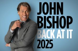 John Bishop standing next to a logo that reads John Bishop Back At It 2025