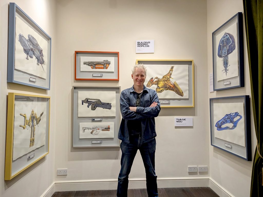 John R Mullaney in the Troubadour Gallery in Soho with some of his framed art. The pieces are available to buy and feature vehicles and weapons from Aliens, Star Wars and Halo