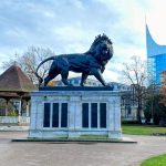 The Maiwand Lion statue and bandstand in Forbury Gardens with The Blade in the background. The venue is the home of Reading Children's Festival opening event, the Forbury Fiesta