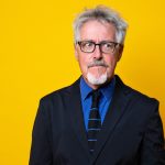 Griff Rhys Jones against a yellow background