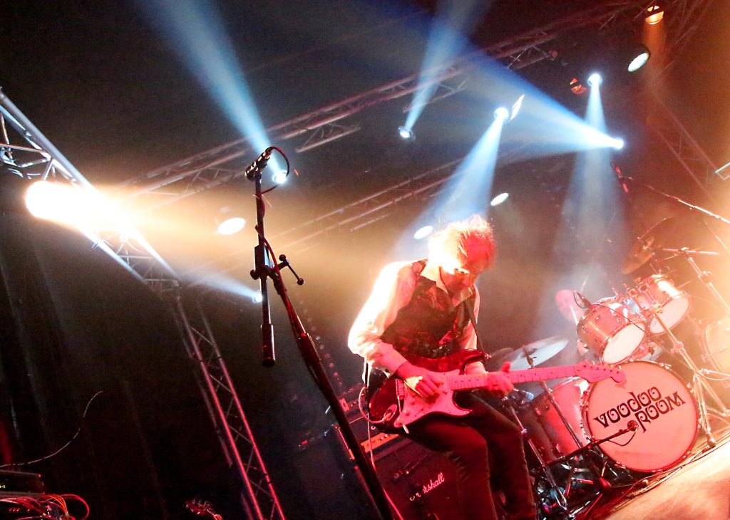 Voodoo Room performing under spotlights