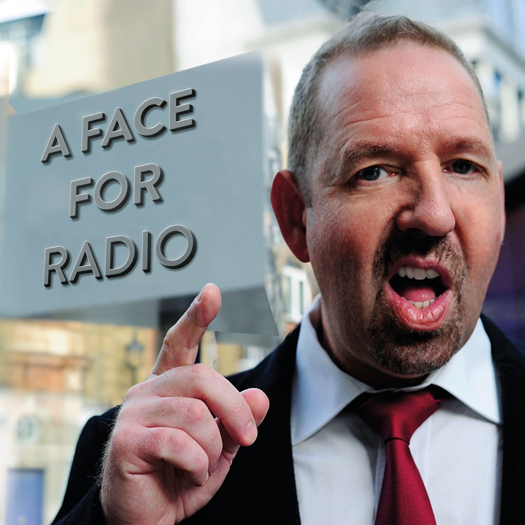 Alfie Moore standing next to a New Scotland Yard sign that has been tweaked to read 'A Face For Radio'. Alfie is pointing and has his mouth open as if in mid-rant.