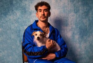Aussie comedian Josh Glanc holding a dog