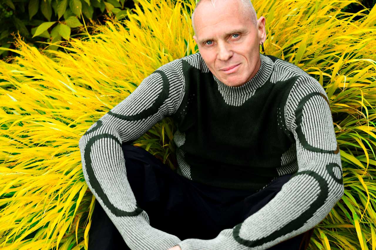 Mr C sitting down against a yellow background