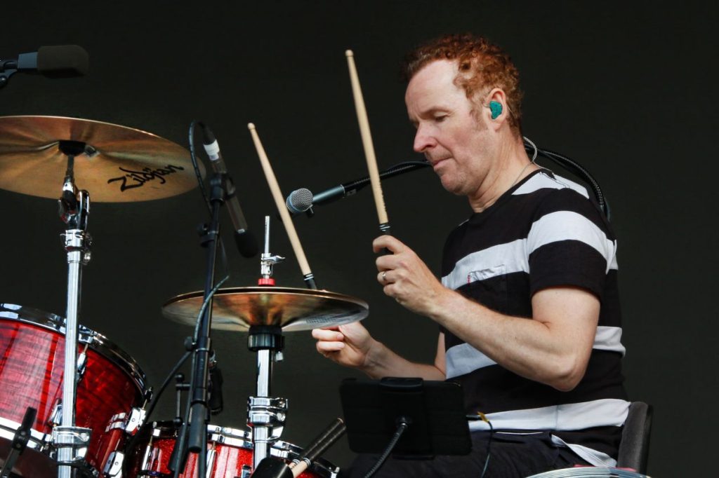 A drummer holding his sticks aloft