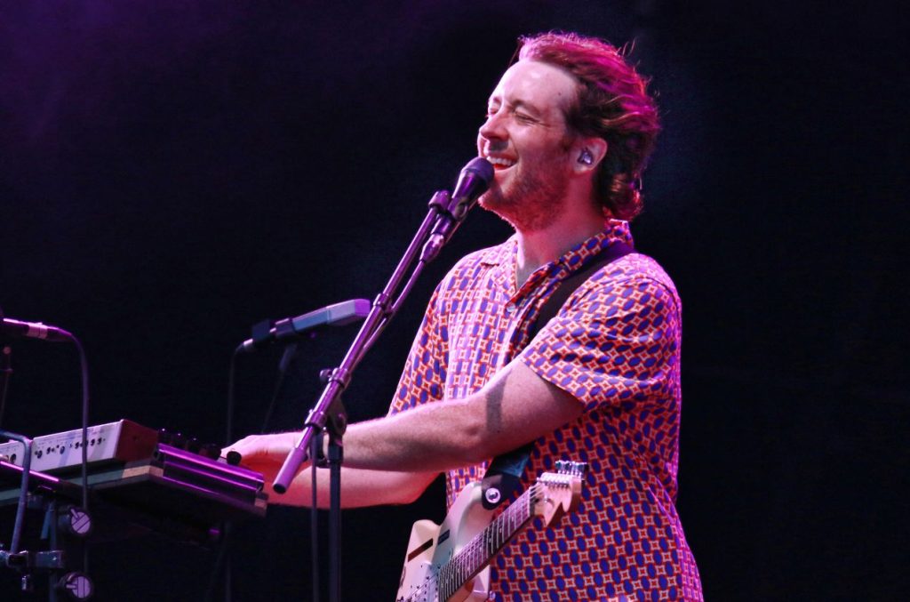 A man singing while playing the piano