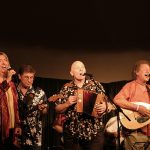 Four musicians performing on the stage of Nettlefield Folk Club
