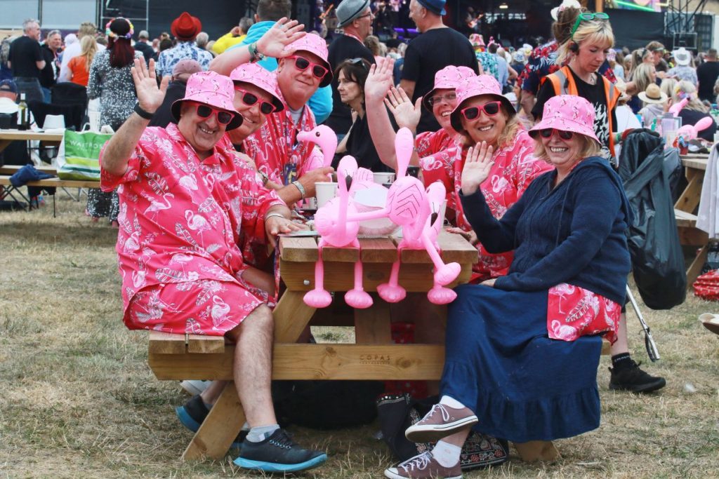 A group of people sitting at a table with inflatables in the middle at Rewind South