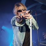 Bon Giovi tribute act - a man singing into a microphone while pointing