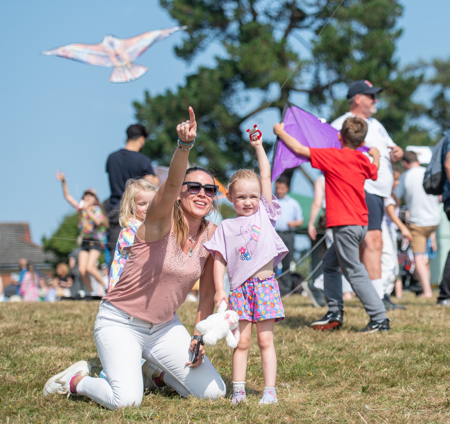 Norden Farm's Kite Festival – a woman and a child flying a kite looking happy