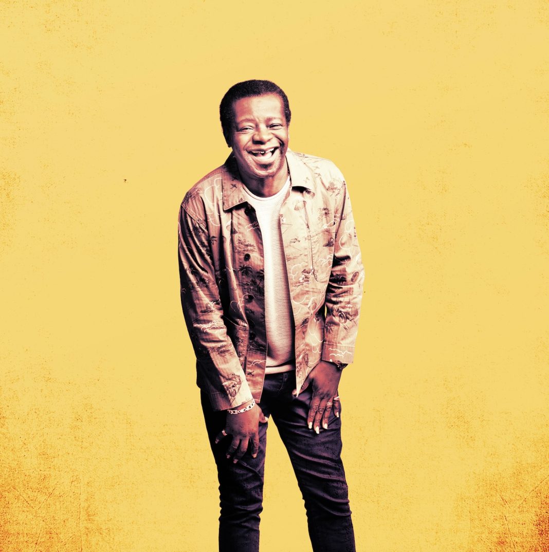 Stephen K Amos against a yellow background